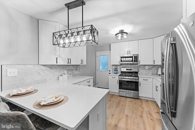 7606 Millrace Rd, Capitol Heights, MD 20743 - kitchen with stainless steel appliances, light countertops, a peninsula, and white cabinetry