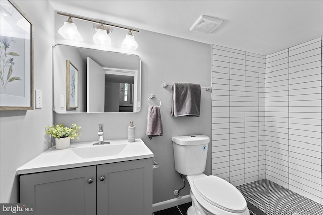 7606 Millrace Rd, Capitol Heights, MD 20743 - bathroom featuring toilet, vanity, a tile shower, and tile patterned floors
