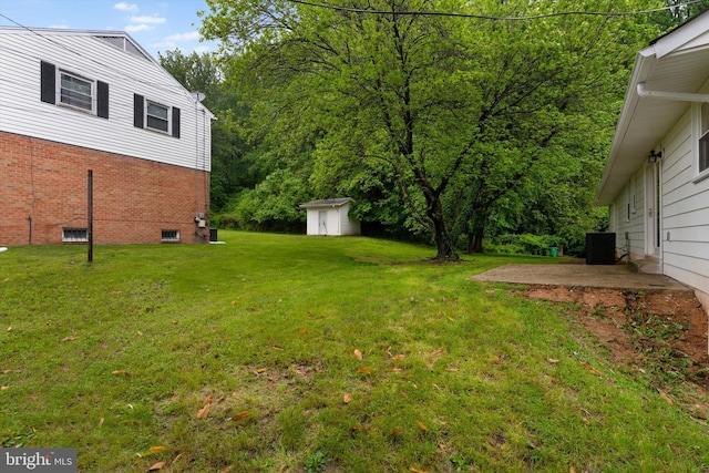 7606 Millrace Rd, Capitol Heights, MD 20743 - view of grassy yard featuring a shed, an outbuilding, central AC, and a patio
