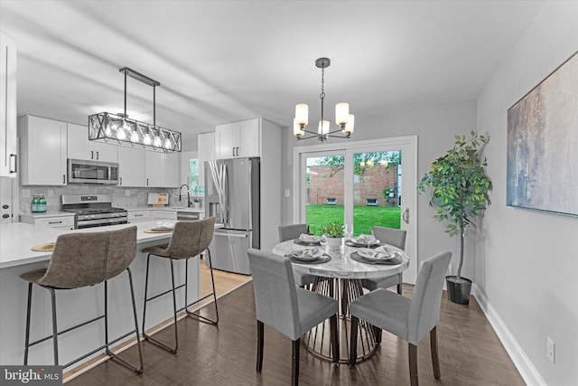 7606 Millrace Rd, Capitol Heights, MD 20743 - dining room with a chandelier, wood finished floors, and baseboards