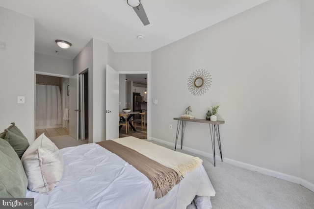 1201 E E W Hwy Unit 208, Silver Spring, MD 20910 - bedroom with baseboards, ensuite bath, and light colored carpet