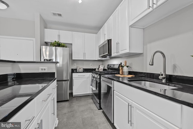 1201 E E W Hwy Unit 208, Silver Spring, MD 20910 - kitchen featuring stainless steel appliances, a sink, white cabinets, dark stone counters, and light flooring