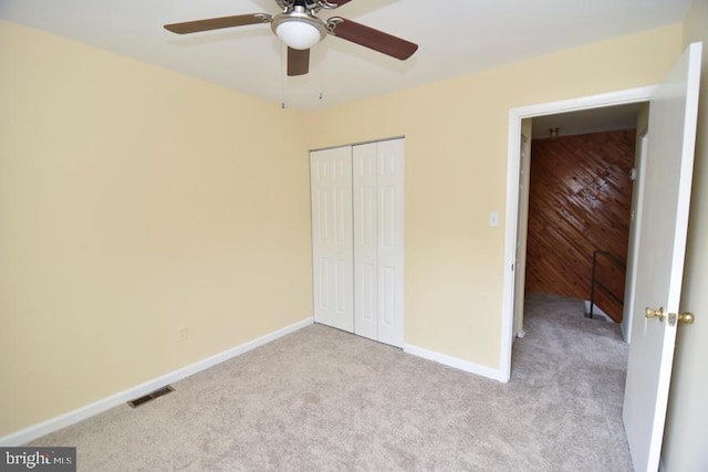3171 Chester Grove Rd, Upper Marlboro, MD 20774 - unfurnished bedroom with carpet flooring, a closet, baseboards, a ceiling fan, and wood walls
