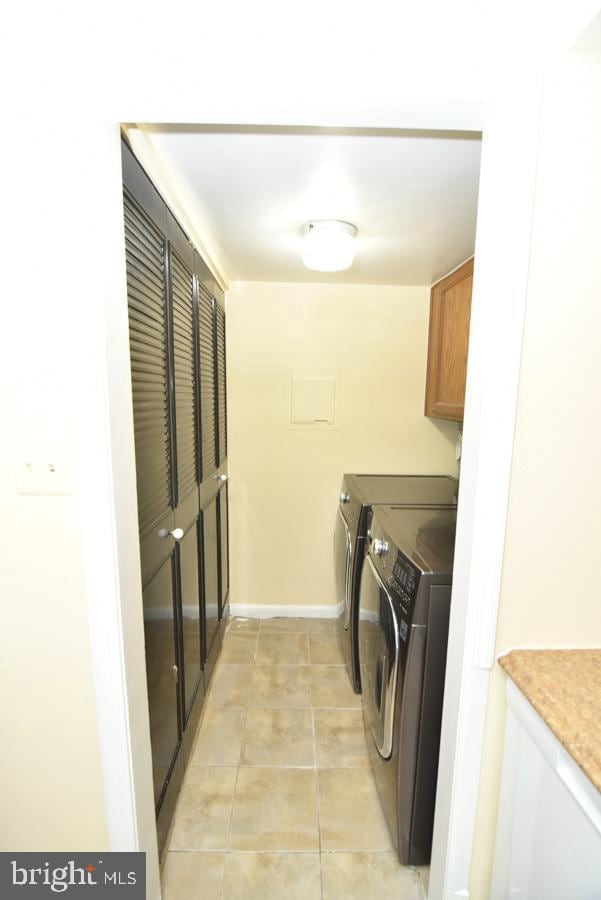 3171 Chester Grove Rd, Upper Marlboro, MD 20774 - laundry room with cabinet space, washing machine and clothes dryer, and light tile patterned floors
