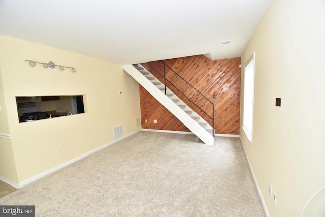 3171 Chester Grove Rd, Upper Marlboro, MD 20774 - unfurnished living room featuring stairs, wood walls, carpet, and baseboards