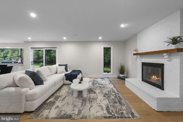18 Haskel Dr, West Windsor, NJ 08550 - living room featuring recessed lighting, a brick fireplace, and light wood-style flooring