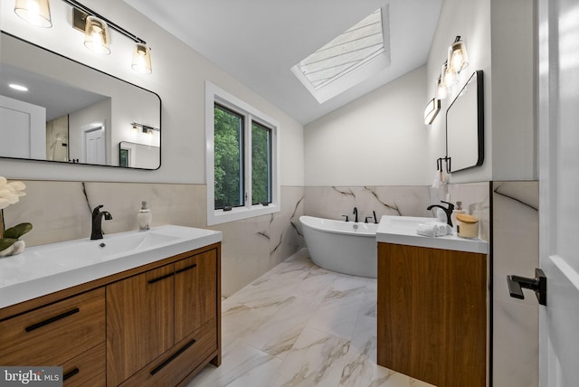 18 Haskel Dr, West Windsor, NJ 08550 - full bath featuring a skylight, tile walls, marble look tile flooring, two vanities, and a freestanding tub