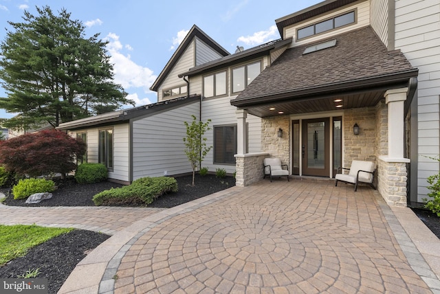 18 Haskel Dr, West Windsor, NJ 08550 - rear view of house with a shingled roof and stone siding