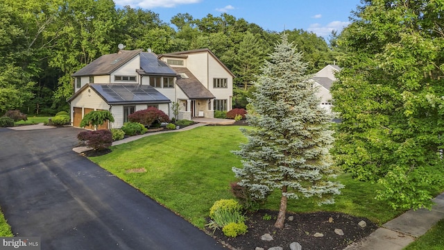 18 Haskel Dr, West Windsor, NJ 08550 - view of front of house with solar panels, a front yard, a garage, and driveway