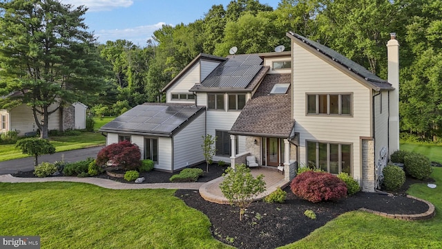 18 Haskel Dr, West Windsor, NJ 08550 - mid-century modern home with solar panels, a front yard, a chimney, and stone siding