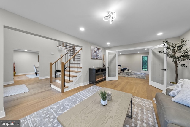18 Haskel Dr, West Windsor, NJ 08550 - living room with stairs, light wood finished floors, french doors, and recessed lighting
