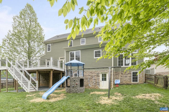 125 Highland Cir, Zion Crossroads, VA 22942 - rear view of property with fence, a playground, stone siding, and a lawn