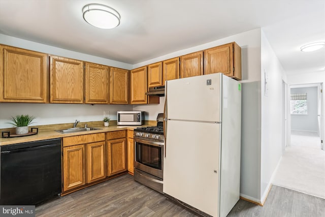 18707 Walkers Choice Rd Unit 6, Gaithersburg, MD 20886 - kitchen featuring stainless steel appliances, under cabinet range hood, a sink, and brown cabinets