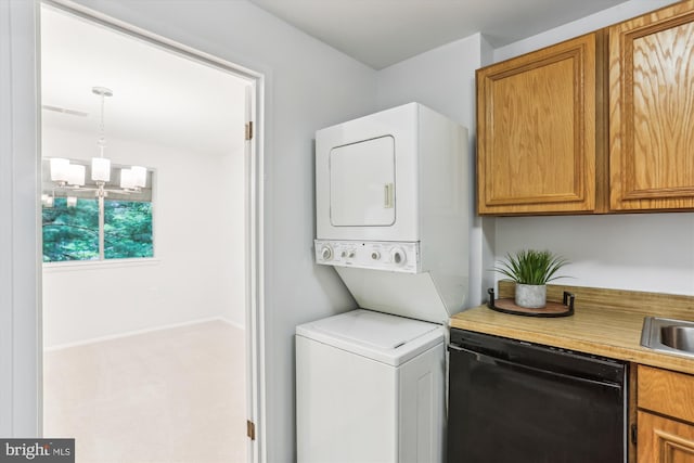 18707 Walkers Choice Rd Unit 6, Gaithersburg, MD 20886 - laundry room featuring stacked washer / dryer, a chandelier, carpet floors, and baseboards