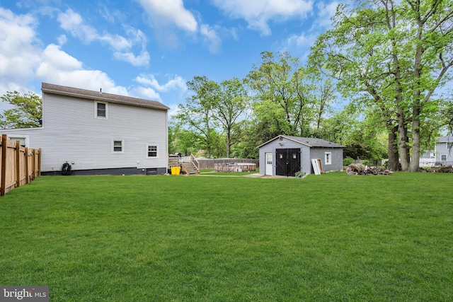 view of yard featuring an outbuilding, a storage unit, and a wooden deck