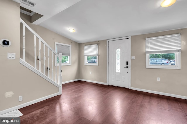 entryway with plenty of natural light, dark wood-type flooring, and baseboards