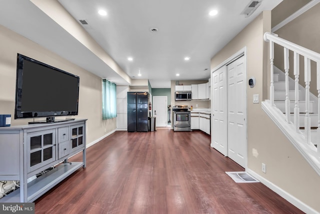 living room with dark wood-type flooring, stairway, baseboards, and recessed lighting