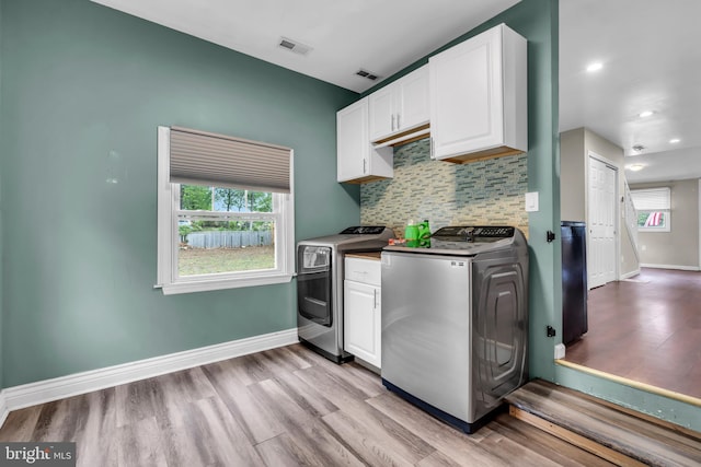 kitchen with light wood finished floors, white cabinetry, backsplash, separate washer and dryer, and recessed lighting