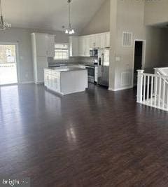 108 Irwin Ct, Hedgesville, WV 25427 - kitchen with an inviting chandelier, high vaulted ceiling, stainless steel microwave, and white cabinets