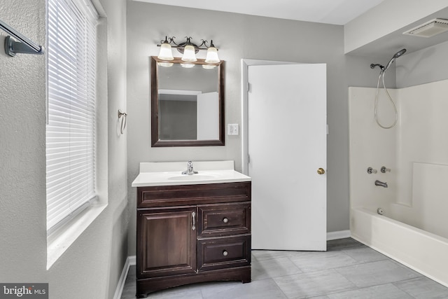 bathroom with  shower combination, vanity, and tile patterned floors