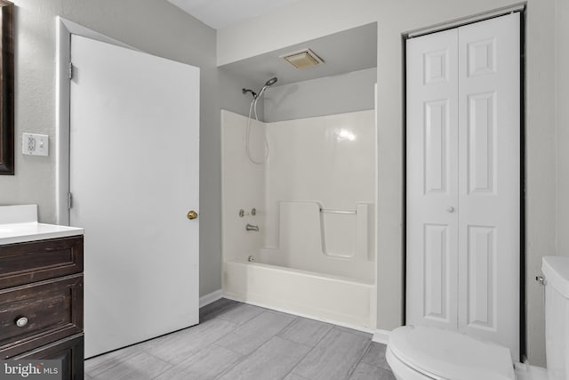 full bath with toilet, vanity, a closet, and shower / bathtub combination