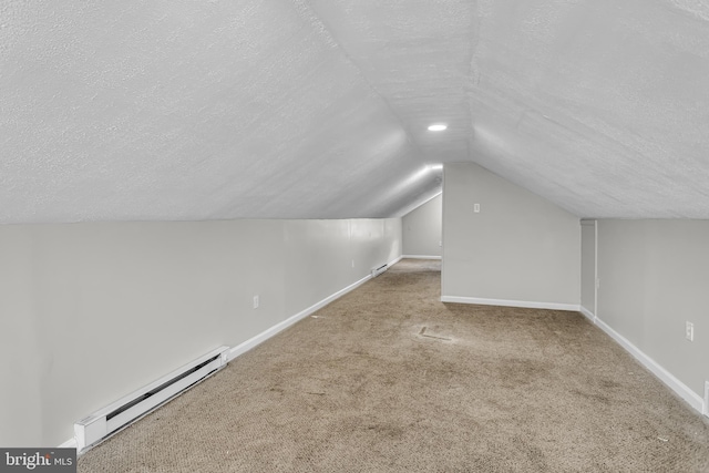 bonus room featuring baseboard heating, a textured ceiling, vaulted ceiling, baseboards, and carpet floors