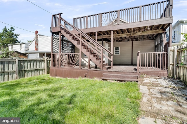 rear view of property featuring a wooden deck and stairway