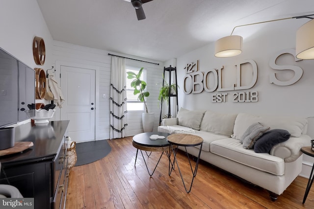living room with hardwood / wood-style floors and ceiling fan