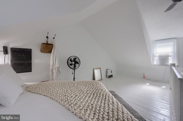 bedroom with lofted ceiling and wood-type flooring