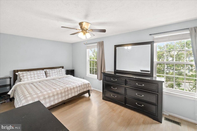 6436 Rockledge Ct, Elkridge, MD 21075 - bedroom featuring baseboards, light wood-style flooring, ceiling fan, and a textured ceiling