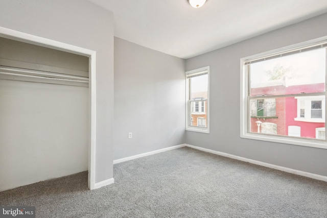 908 Mckean Ave, Baltimore, MD 21217 - unfurnished bedroom with carpet flooring, a closet, and baseboards