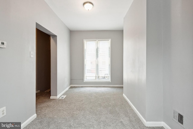 908 Mckean Ave, Baltimore, MD 21217 - empty room with baseboards, visible vents, and carpet