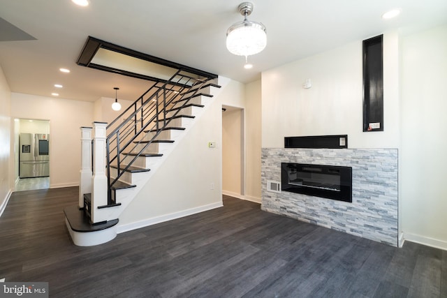 unfurnished living room with stairway, wood finished floors, baseboards, and recessed lighting