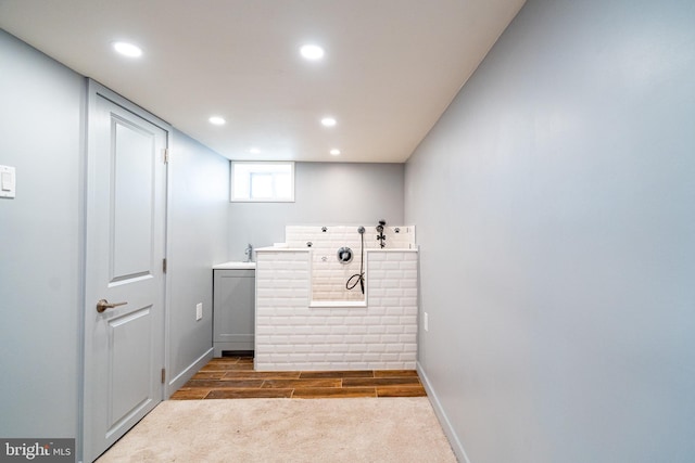 clothes washing area featuring carpet, baseboards, and recessed lighting