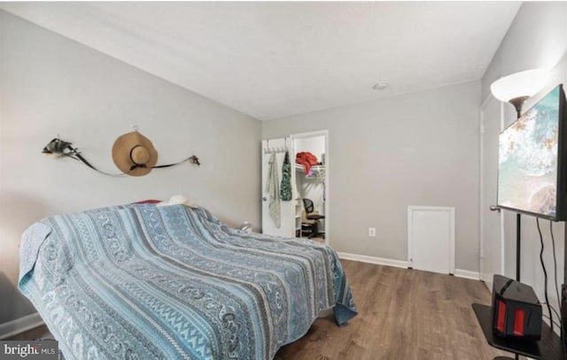 3841 Saint Barnabas Rd Unit 3843T, Suitland, MD 20746 - bedroom featuring wood finished floors, baseboards, and a walk in closet