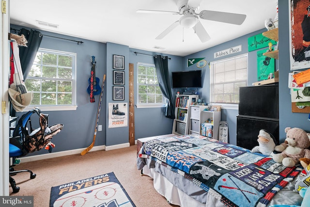 bedroom with multiple windows, carpet flooring, baseboards, and ceiling fan
