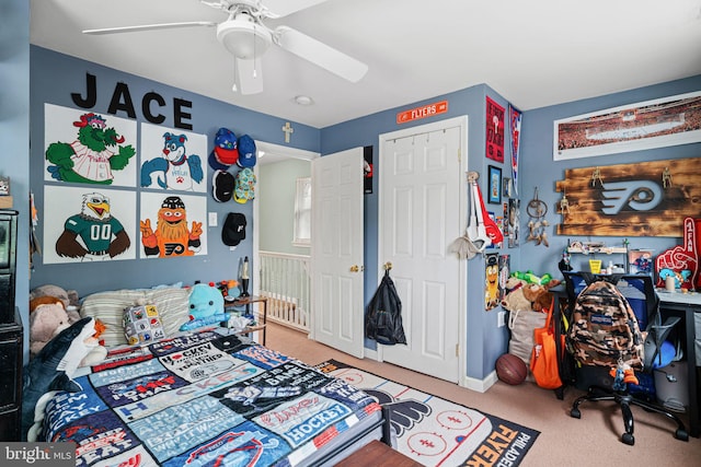 carpeted bedroom with a ceiling fan and baseboards