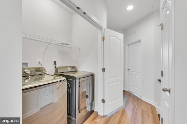 5992 Passend Dr, Frederick, MD 21703 - clothes washing area featuring washer and dryer, light wood-type flooring, and baseboards