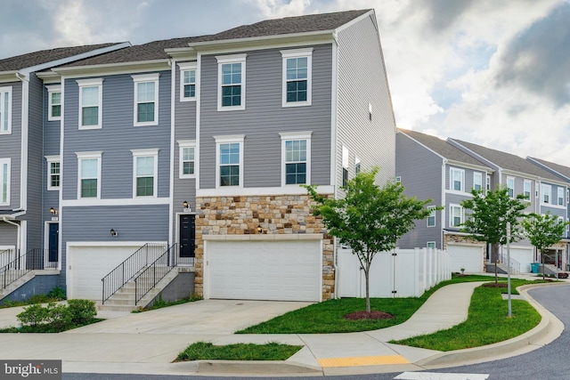 5992 Passend Dr, Frederick, MD 21703 - multi unit property featuring stone siding, concrete driveway, an attached garage, and fence