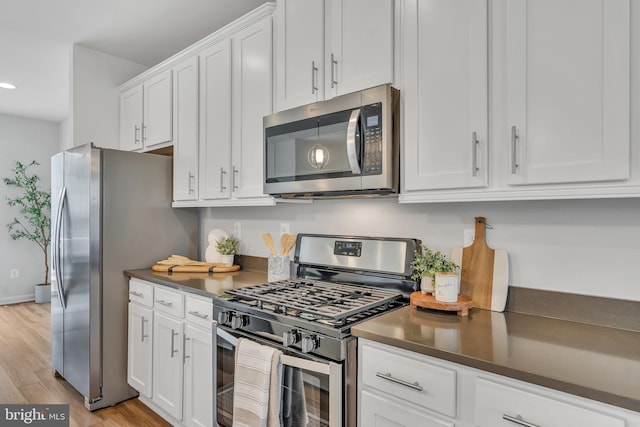 5992 Passend Dr, Frederick, MD 21703 - kitchen featuring stainless steel appliances, white cabinets, dark countertops, light wood-style flooring, and recessed lighting