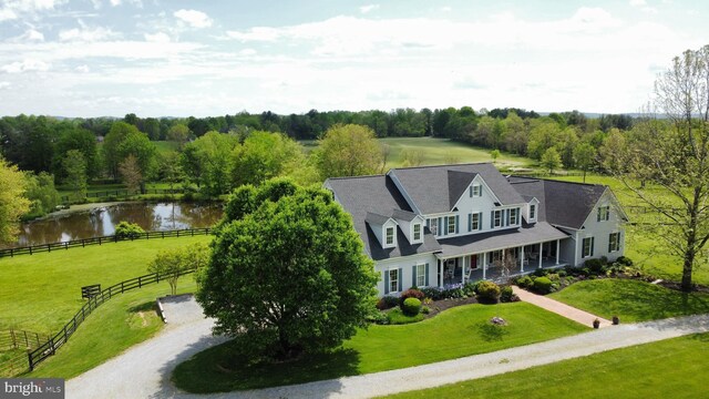 aerial view of property and surrounding area featuring a large body of water