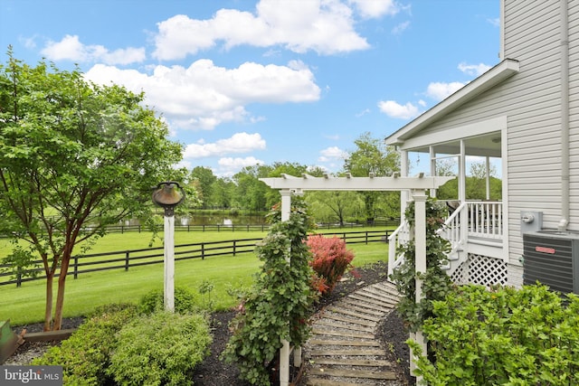 view of yard featuring cooling unit, a sunroom, and a water view