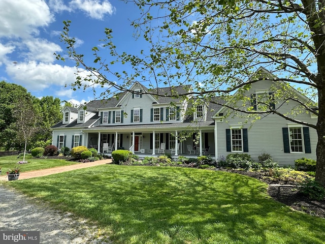 view of front facade with covered porch and a front yard