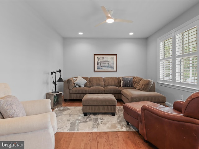 living room featuring wood finished floors, a ceiling fan, and recessed lighting
