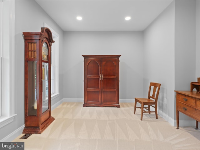 living area featuring baseboards, light colored carpet, and recessed lighting