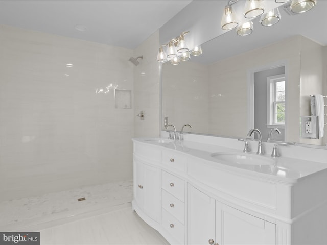 full bath with tiled shower and double vanity
