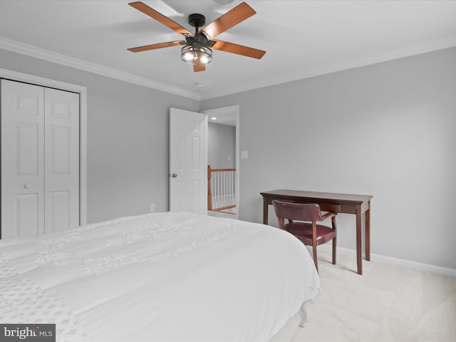bedroom with crown molding, baseboards, a ceiling fan, light carpet, and a closet