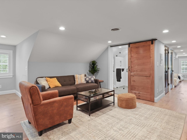 living area with light wood-style flooring, recessed lighting, baseboards, and vaulted ceiling