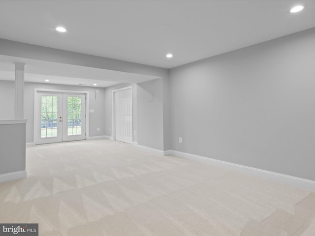 empty room with light carpet, recessed lighting, french doors, and baseboards