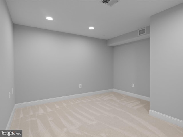 finished basement featuring light colored carpet, recessed lighting, and baseboards